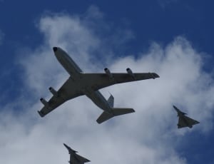 three airplanes under blue sky thumbnail