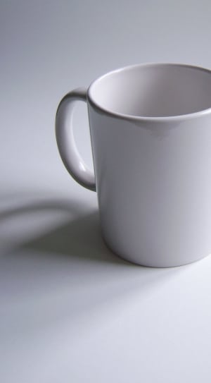 close up photography of a white ceramic mug on top of a white surface thumbnail