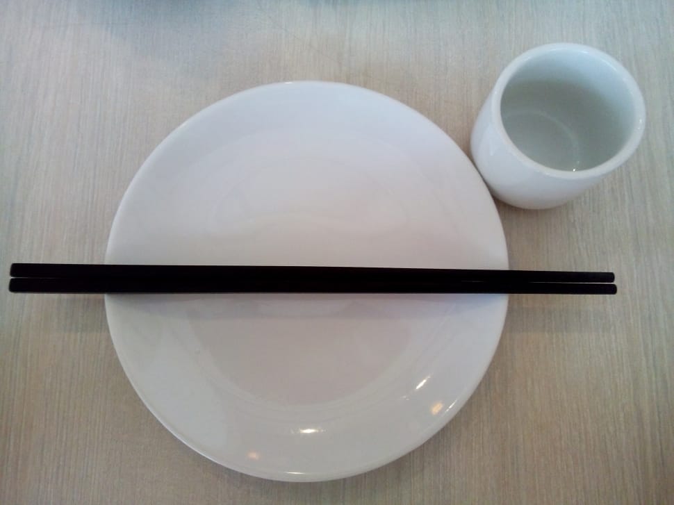 black chopsticks on white ceramic plate preview