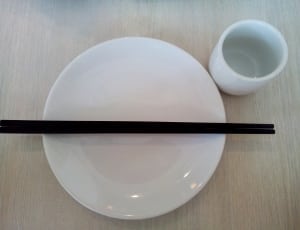 black chopsticks on white ceramic plate thumbnail