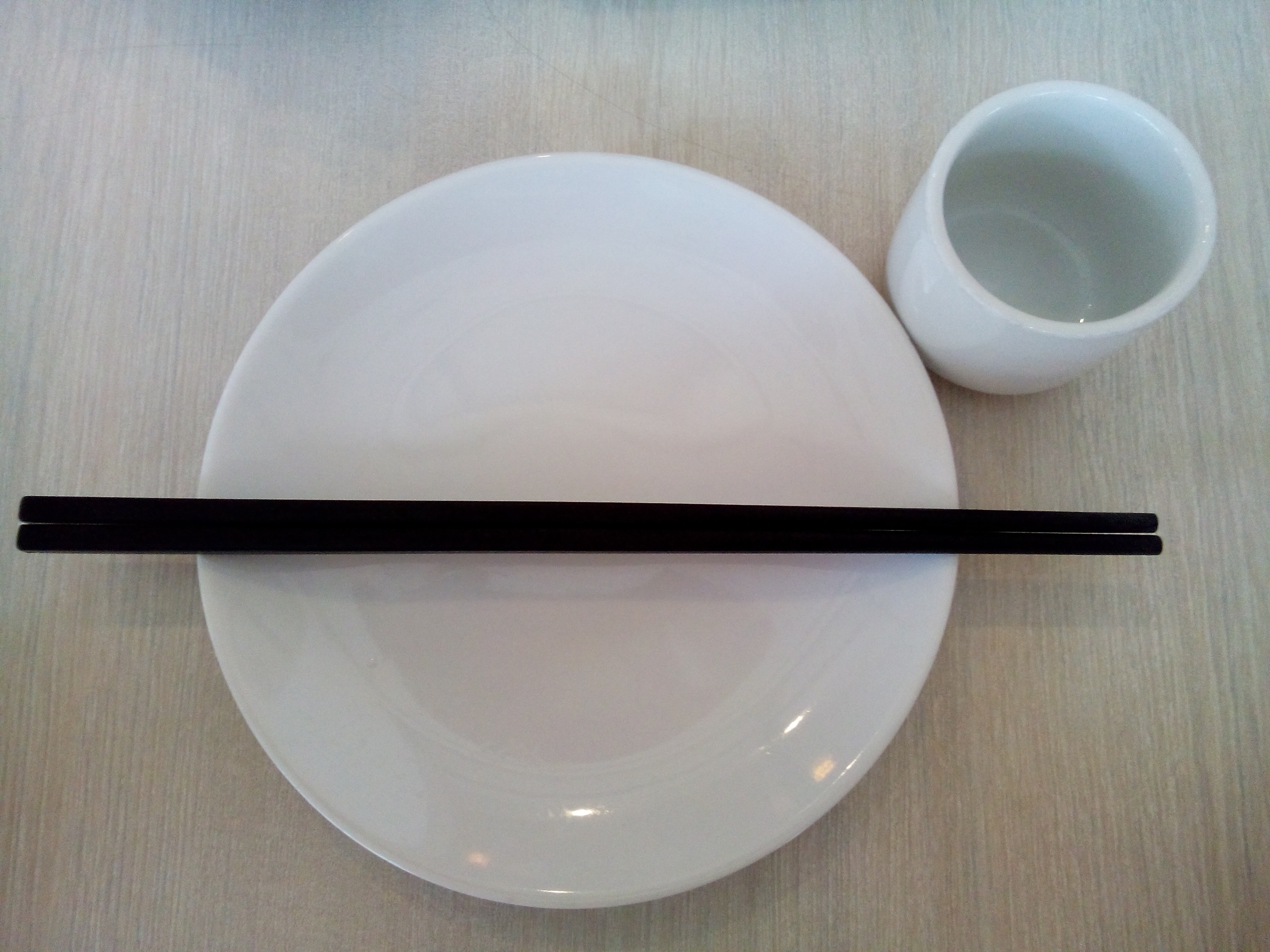 black chopsticks on white ceramic plate