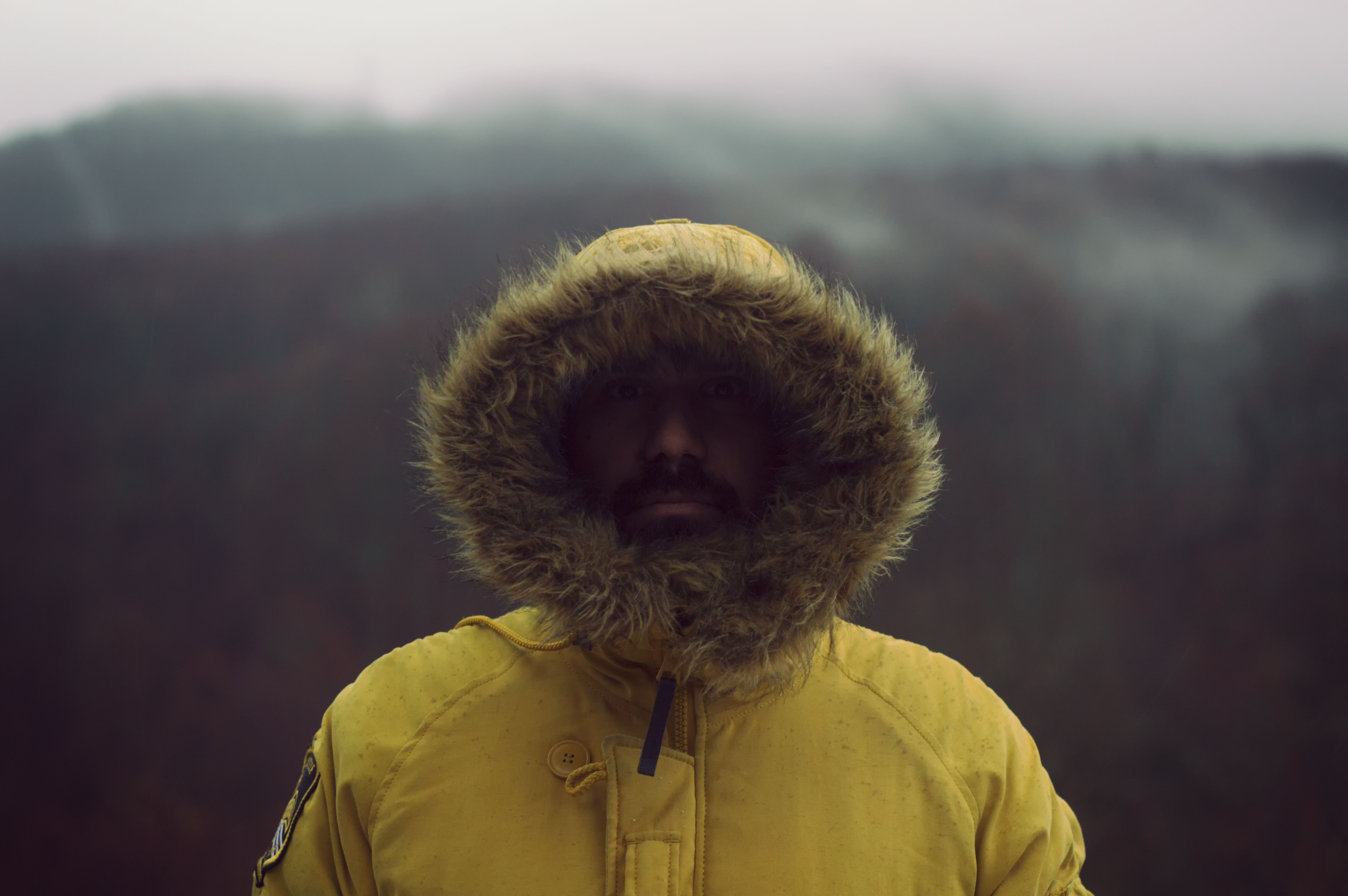 man in yellow and brown parka jacket