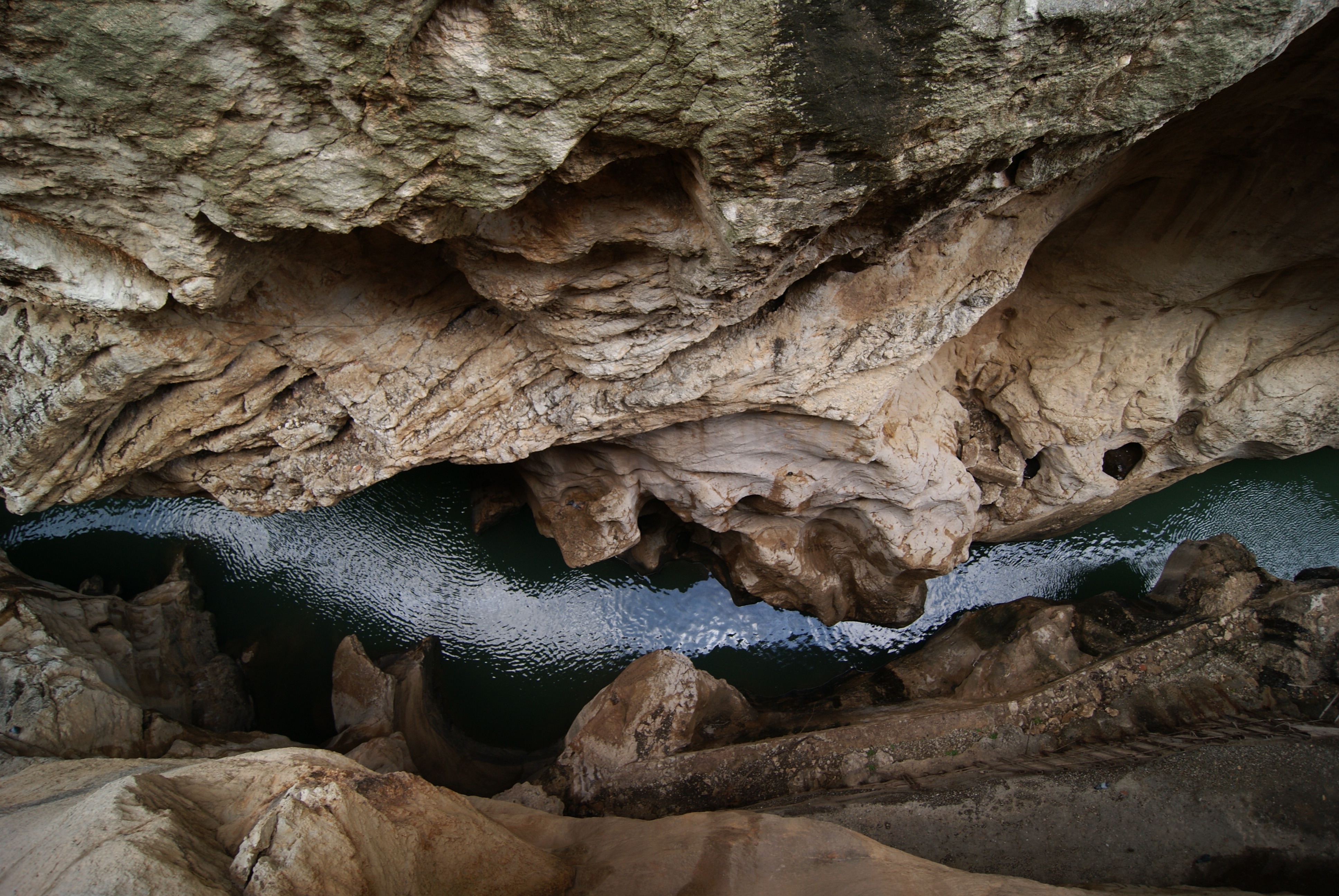 body of water in between of beige rock