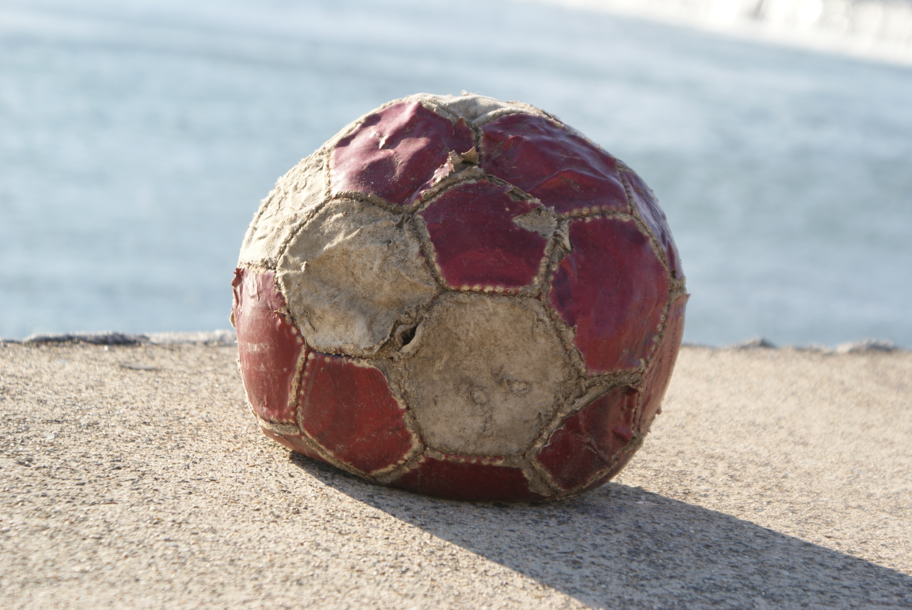 maroon and white soccer ball
