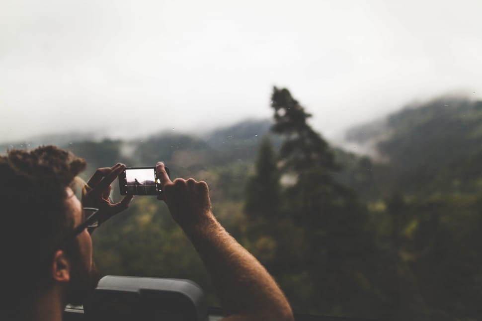 person taking a photo using his smartphone preview