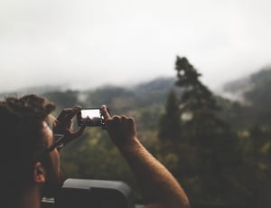 person taking a photo using his smartphone thumbnail