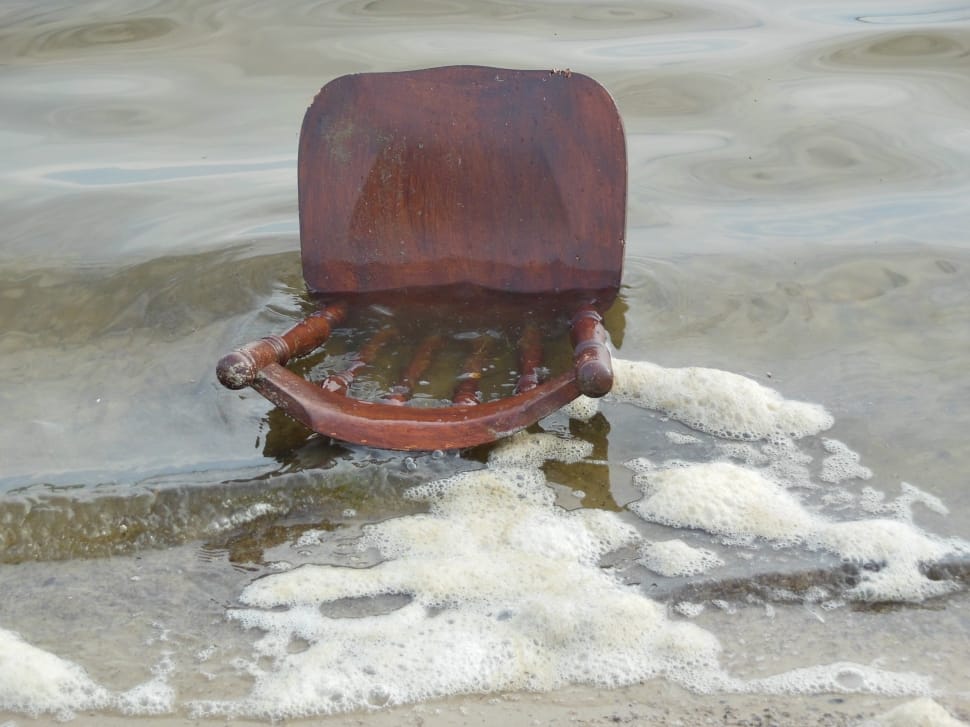 brown wooden chair on beach line preview