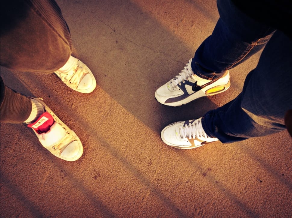 two person in sneakers standing on a cement floor preview