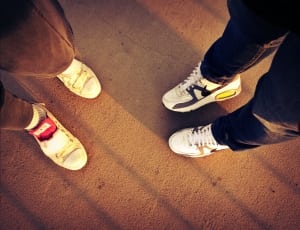 two person in sneakers standing on a cement floor thumbnail