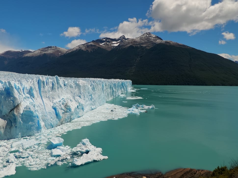 ice berg and mountain during daytime preview