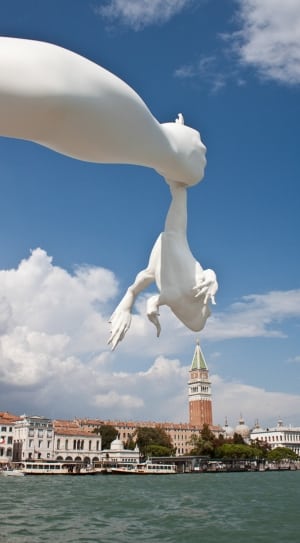 person holding frog statue thumbnail