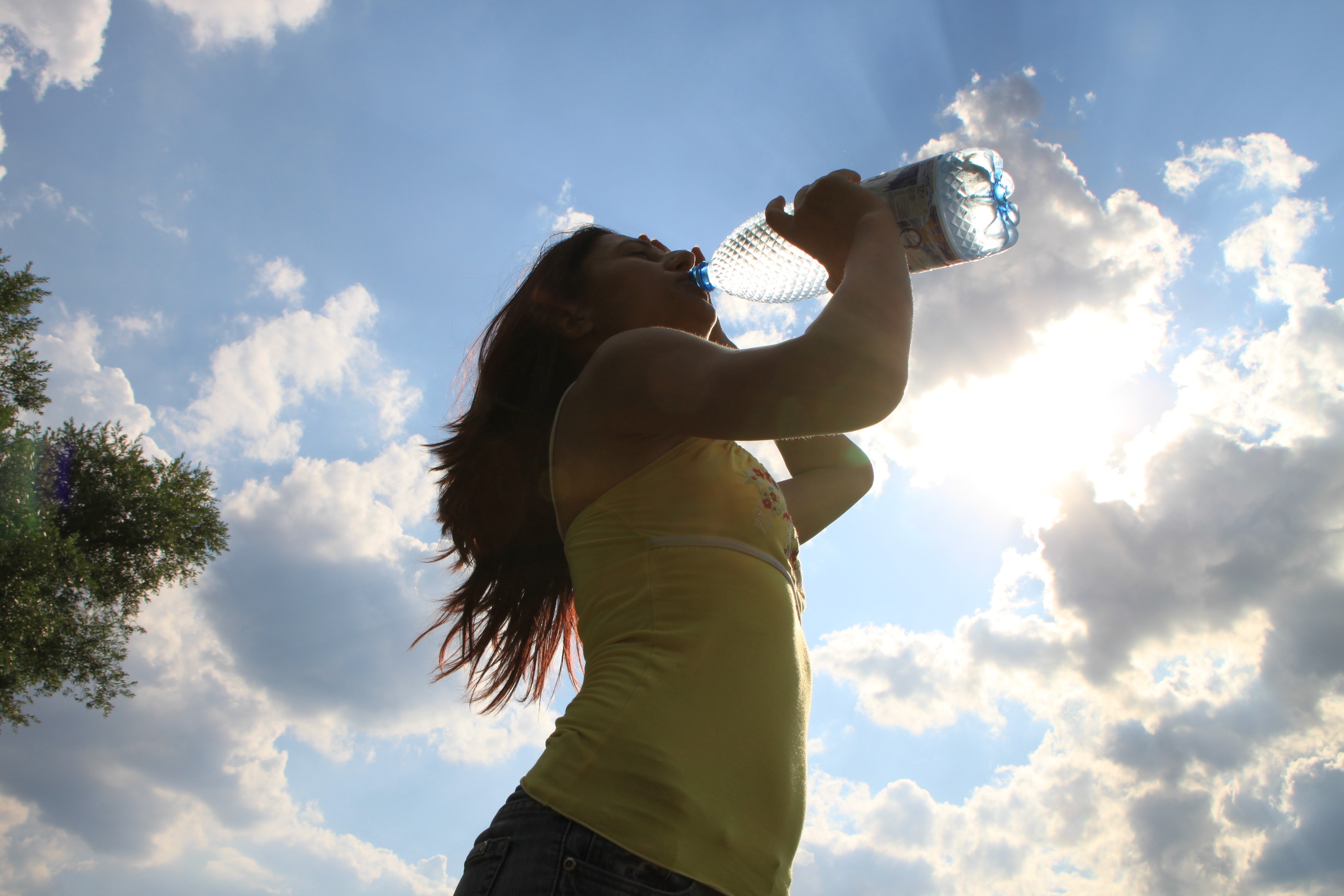 woman drinking using plastic bottle