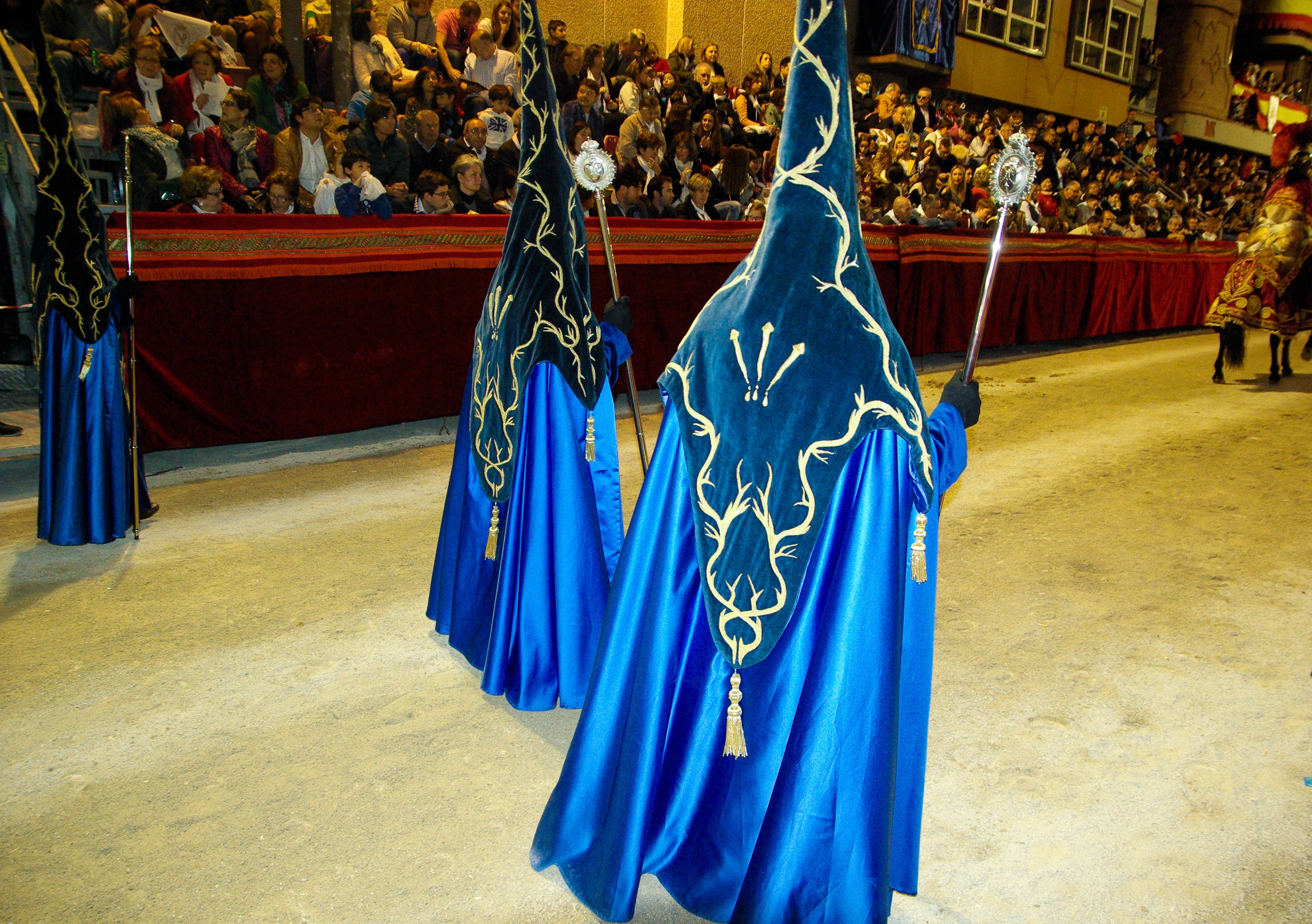three person wearing blue costume in parade