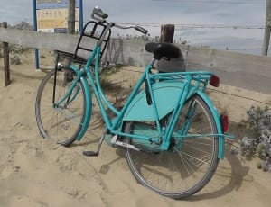 teal beach cruiser bicycle on sand thumbnail