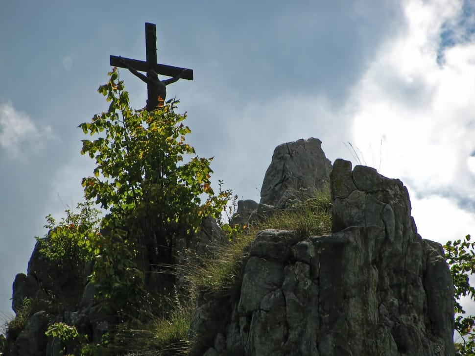 brown cross on top of rock during daytime preview