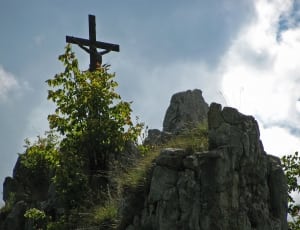 brown cross on top of rock during daytime thumbnail