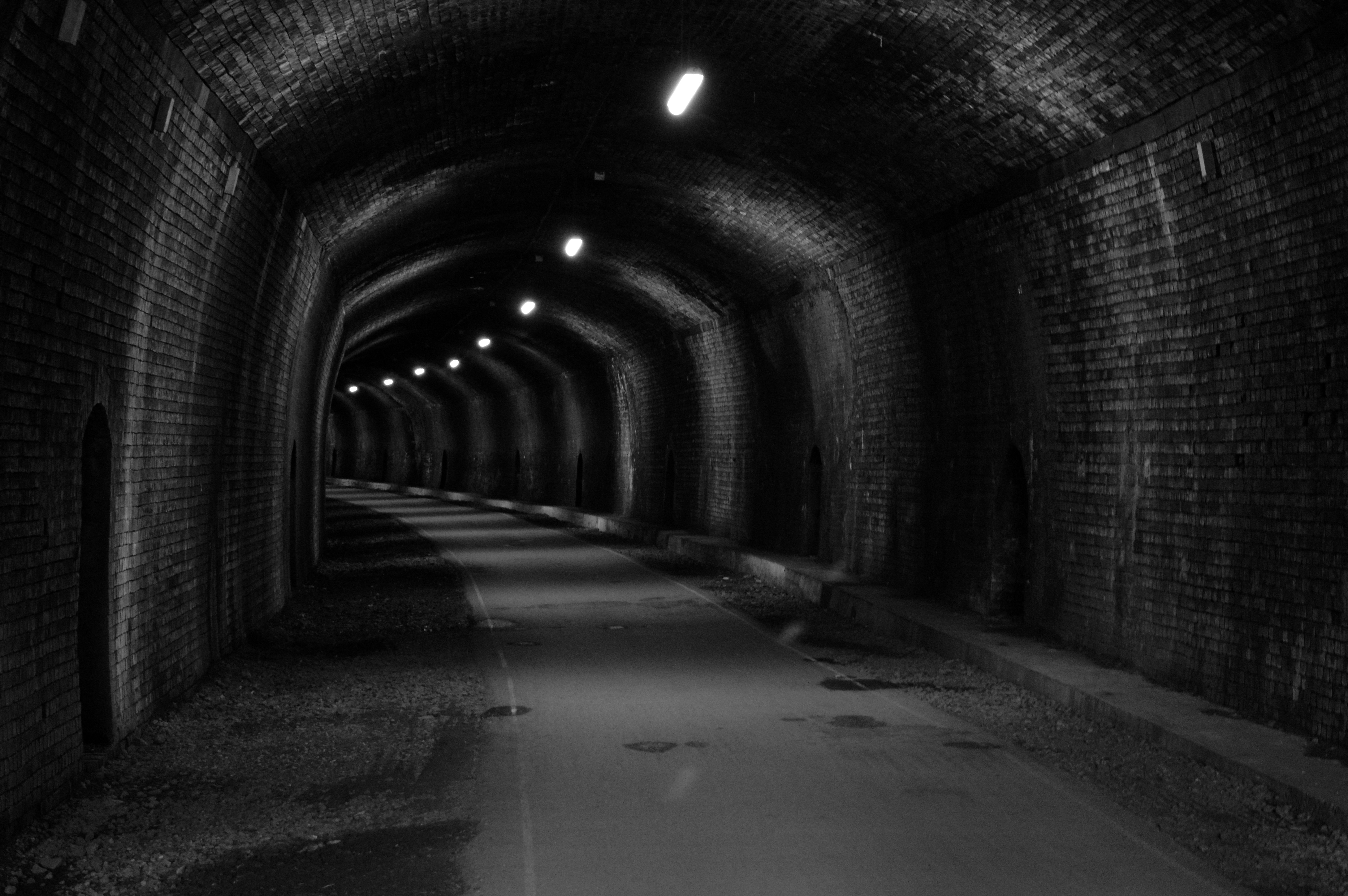 greyscale photo of underground pathway