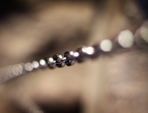 selective focus photography of silver chain accessory thumbnail