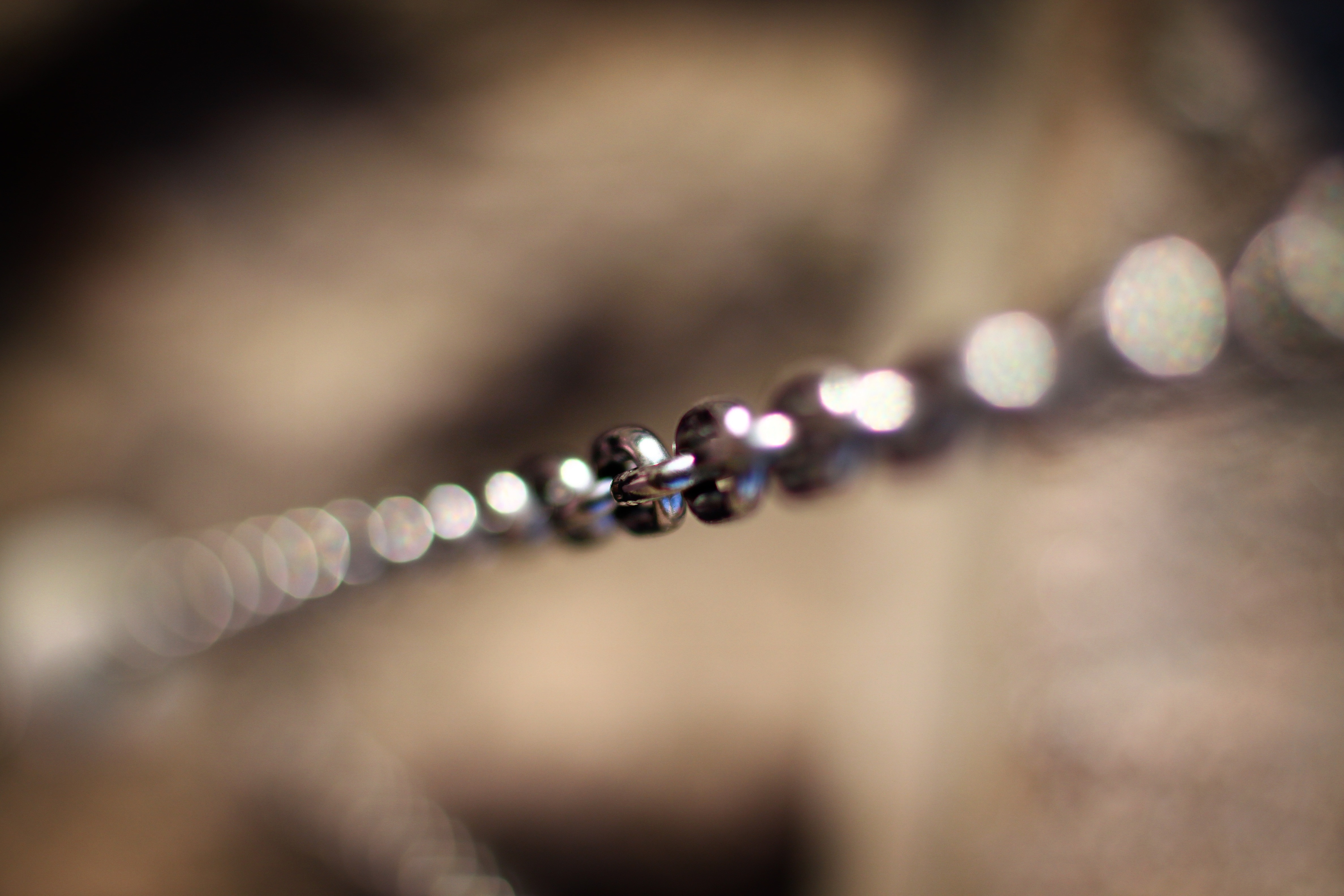 selective focus photography of silver chain accessory