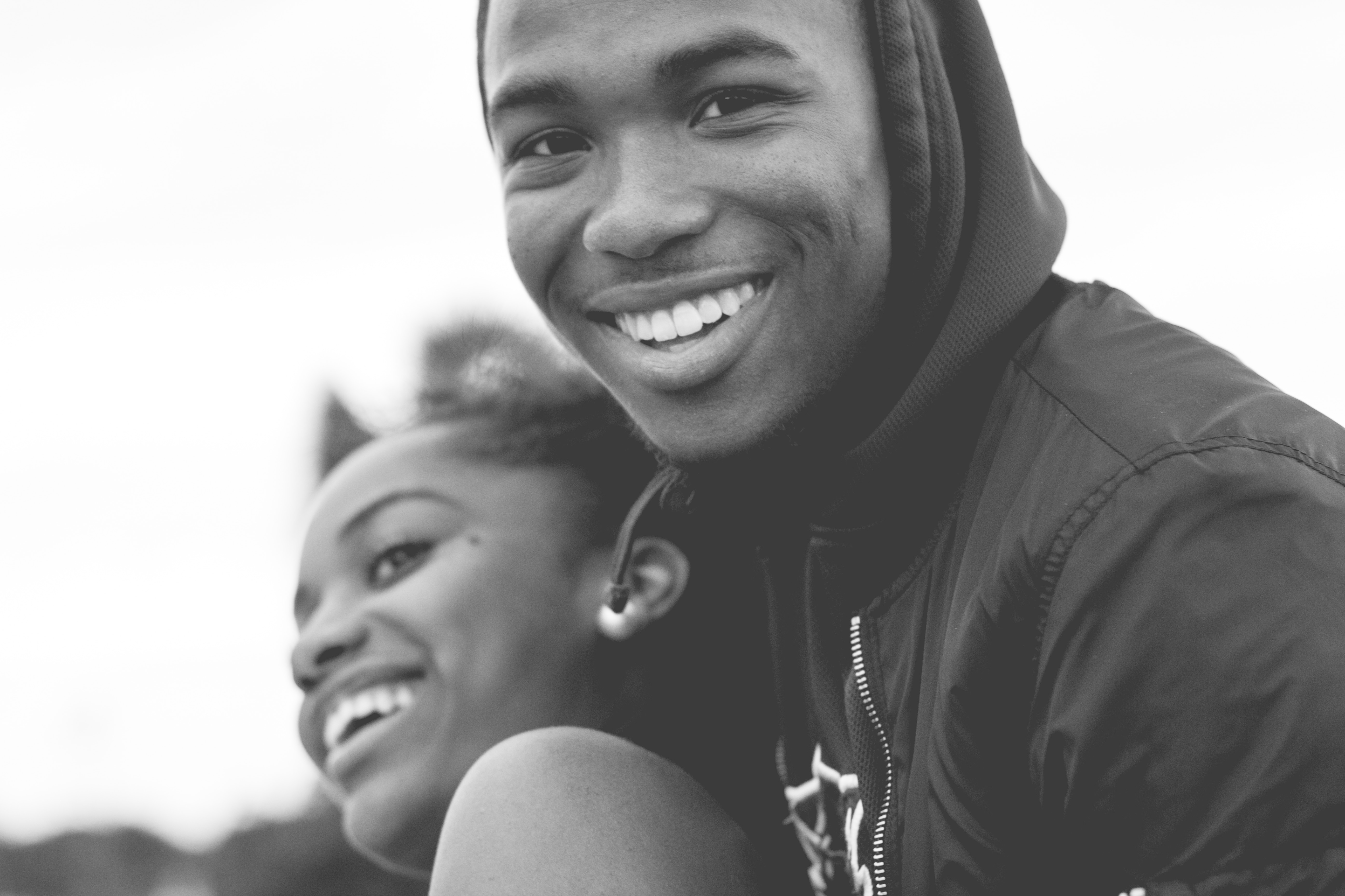 smiling man and woman in grayscale photography