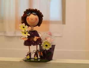 brown and yellow sunflower and doll figurine thumbnail