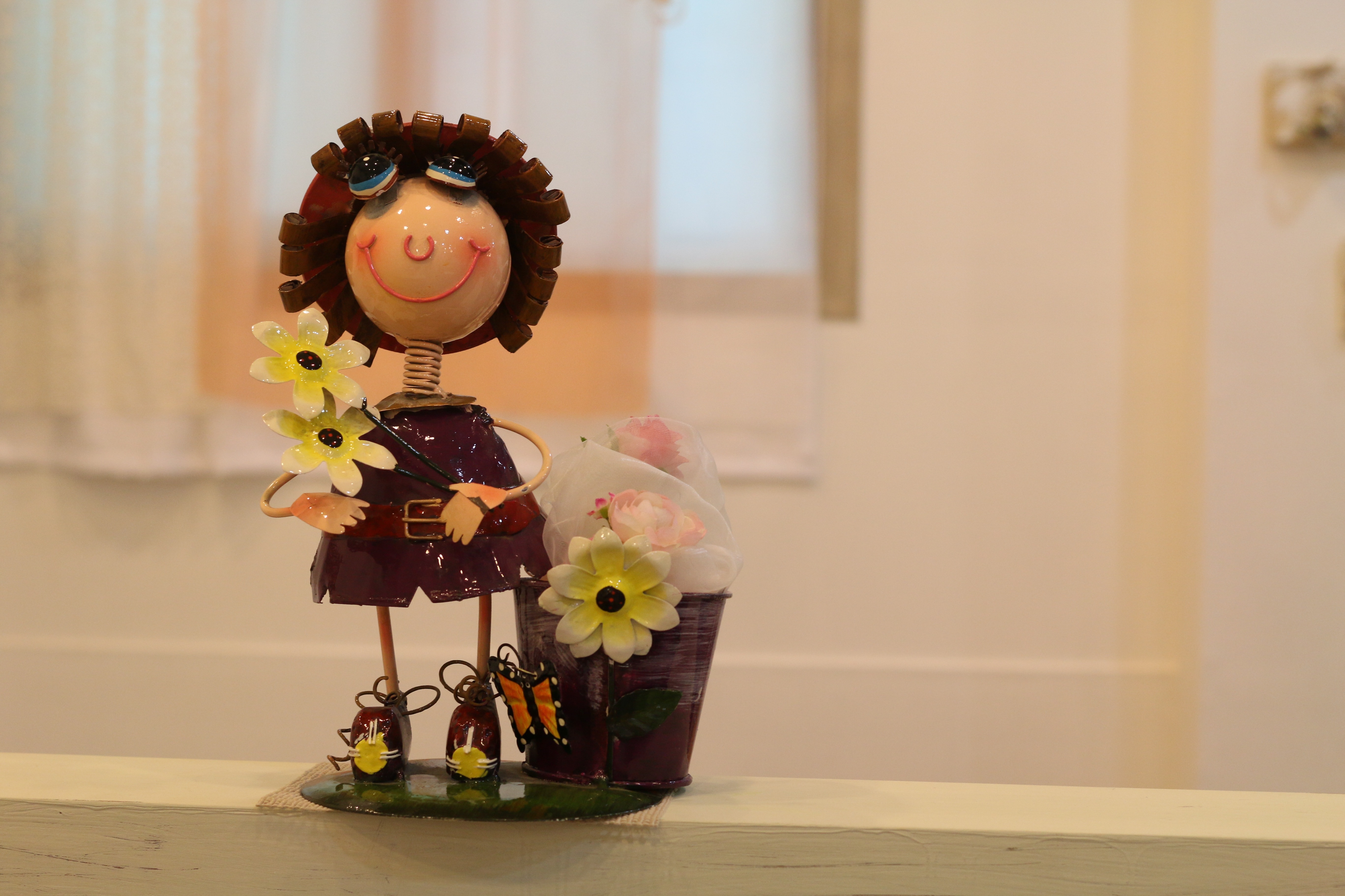 brown and yellow sunflower and doll figurine
