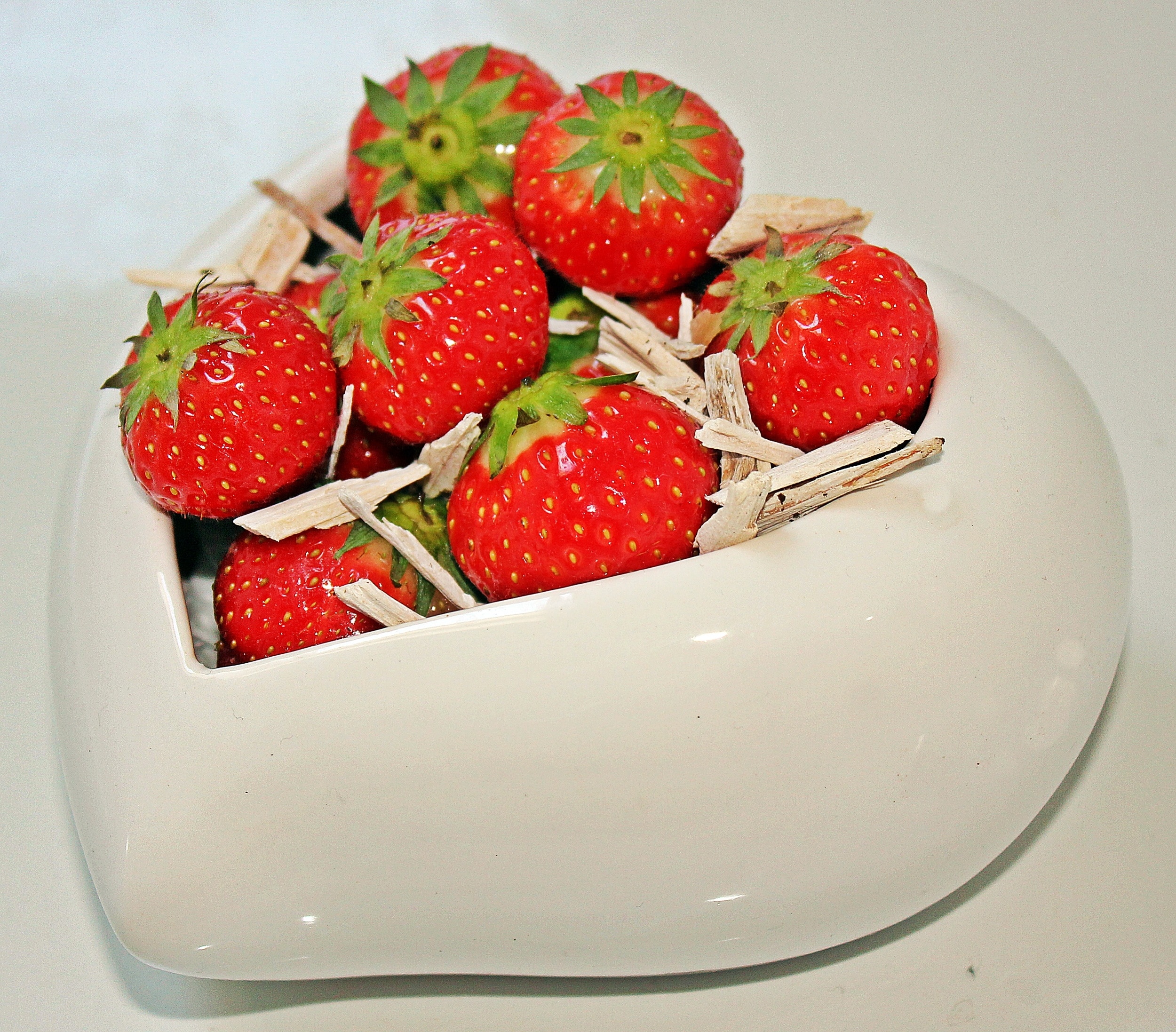 white ceramic heart bowl with strawberries