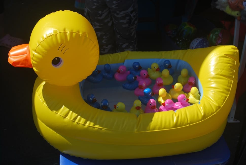 yellow duck inflatable pool with assorted rubber duckies preview