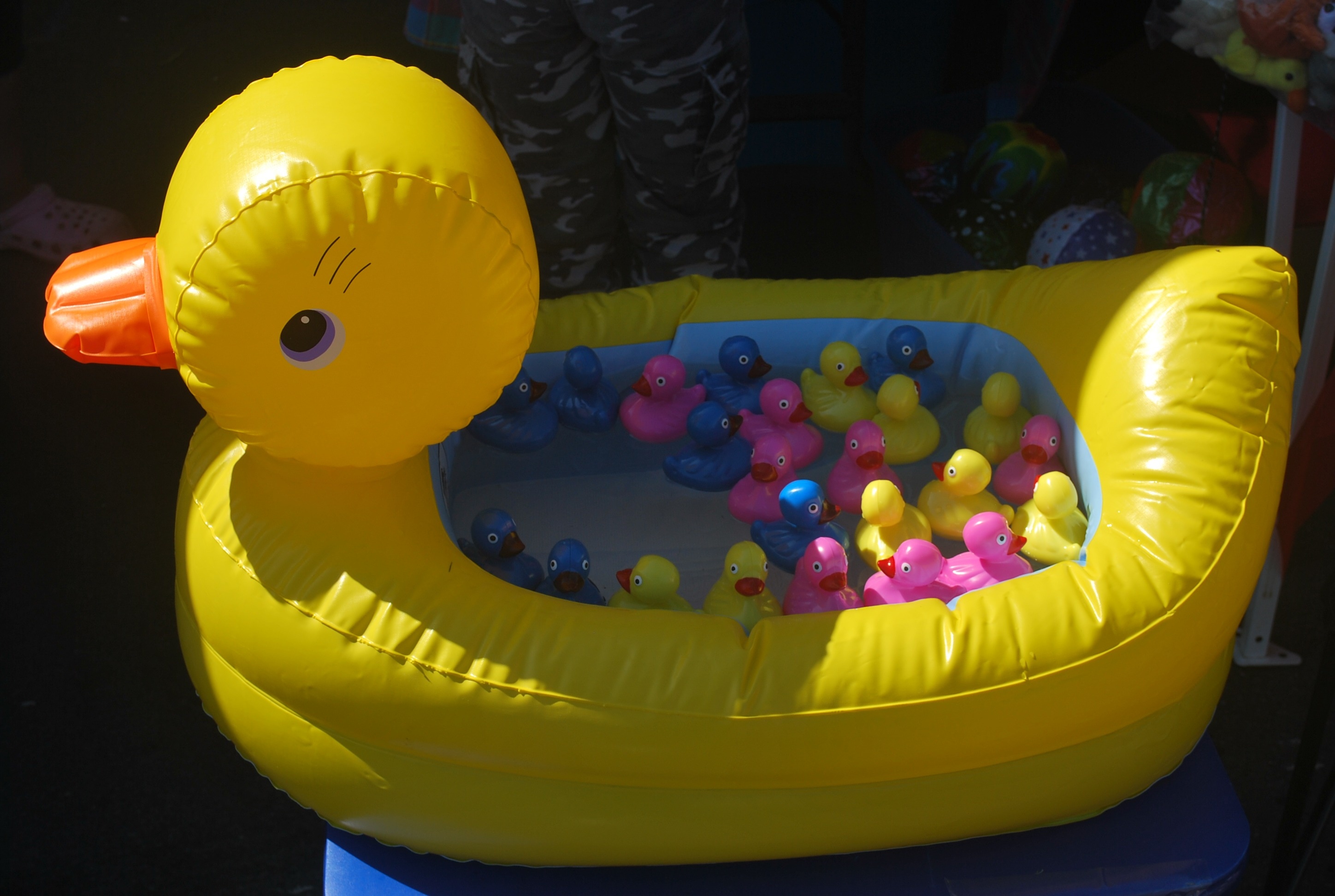 yellow duck inflatable pool with assorted rubber duckies