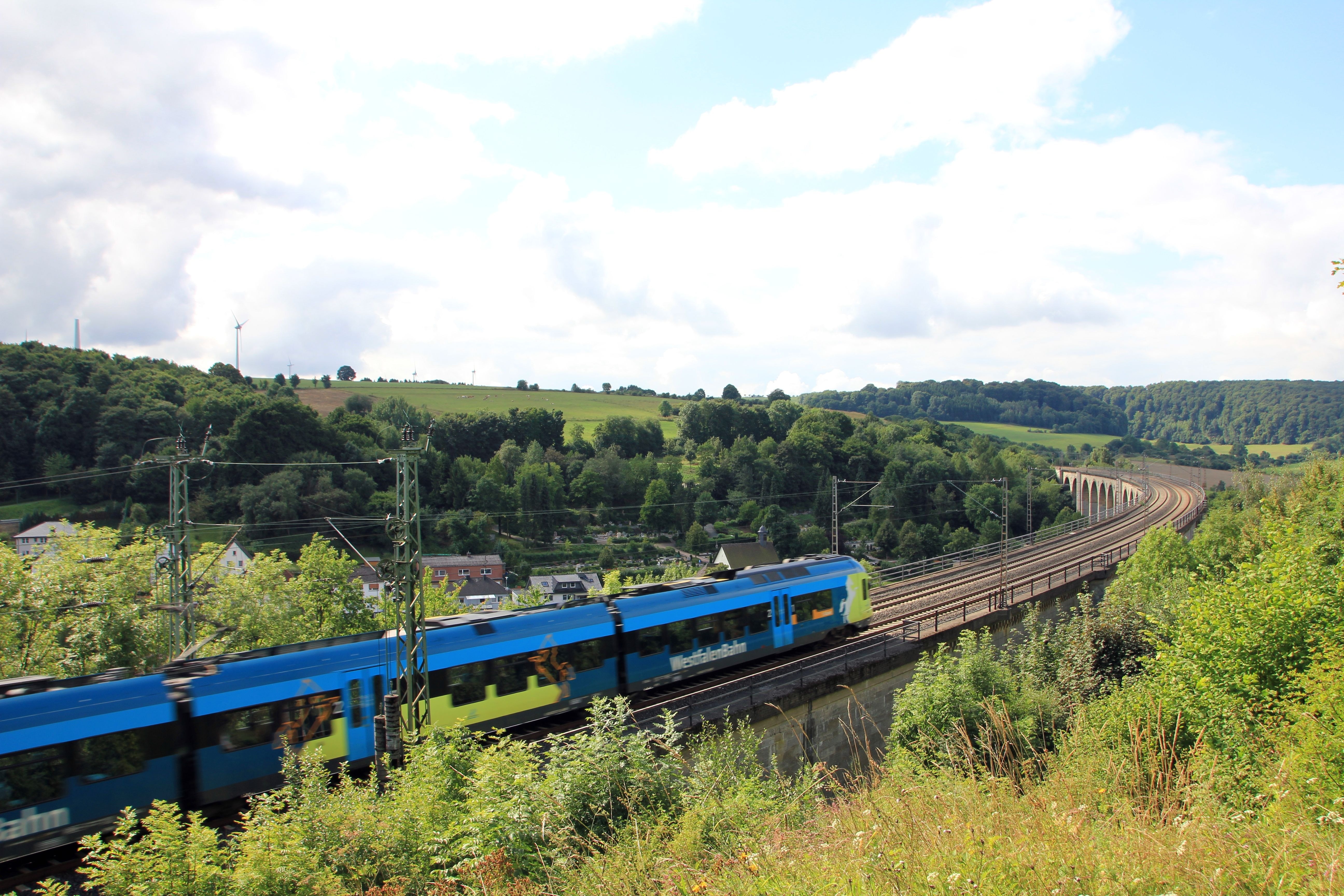 blue train on railway during daytime