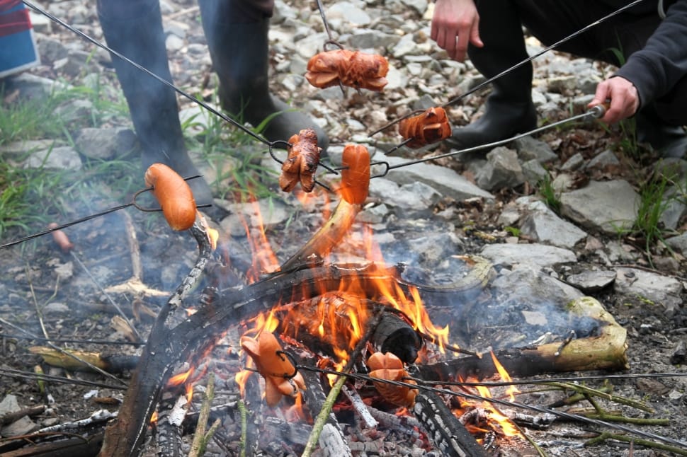 people roasting food on gray metal rods photo preview