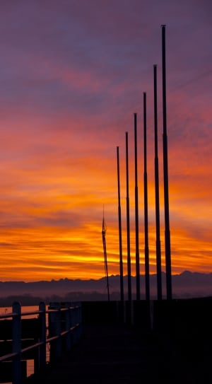 silhouette of 6 utility post during sunset thumbnail