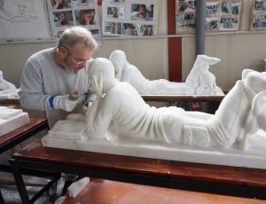 white ceramic man laying down statuette thumbnail