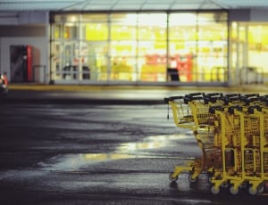 yellow steel shopping cards near grocery store in shallow focus photography thumbnail