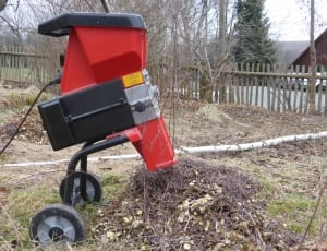 red and black corded machine near wooden fence during daytime thumbnail