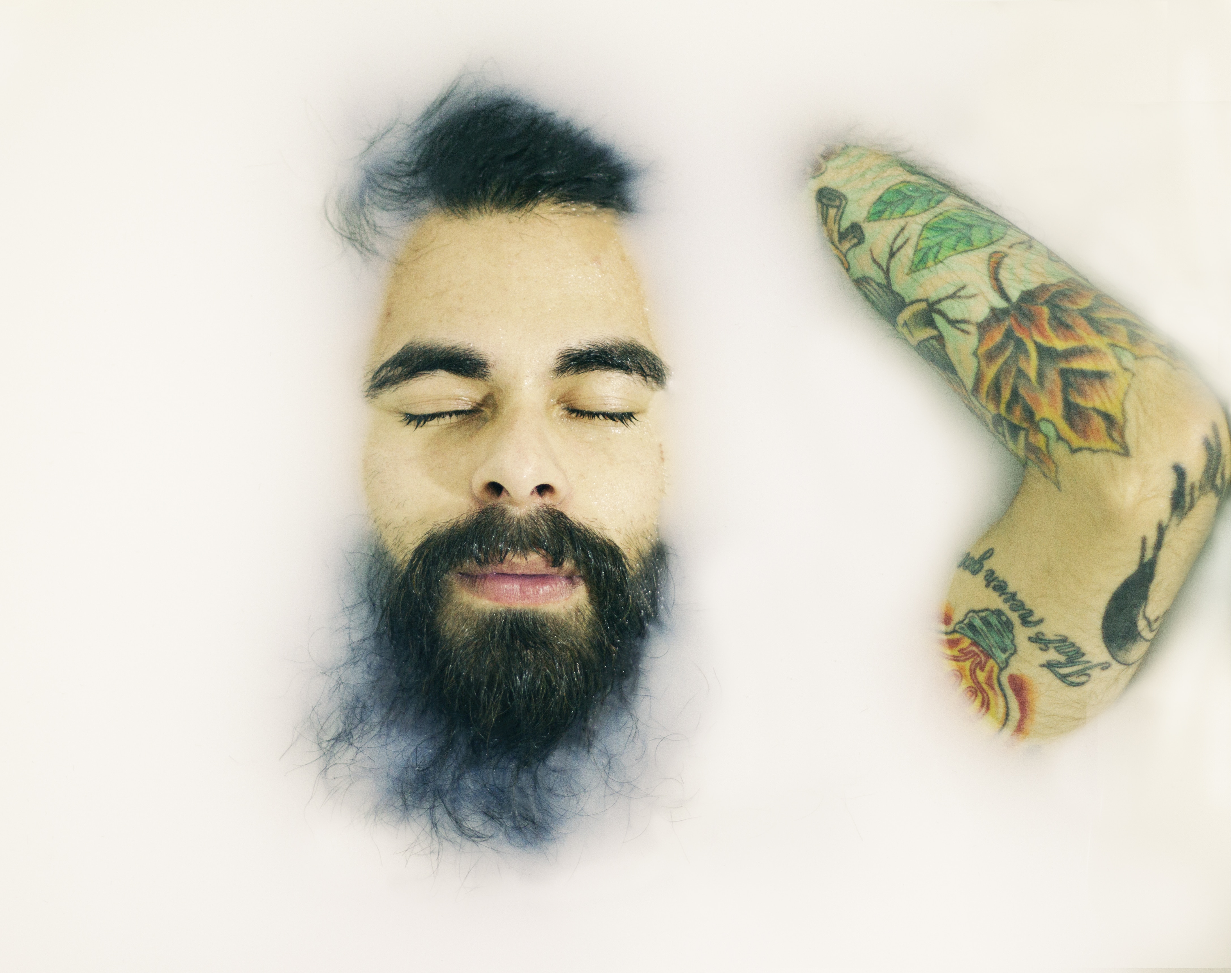 man with beard and arm tattoo