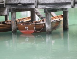 2 brown wooden row boats thumbnail