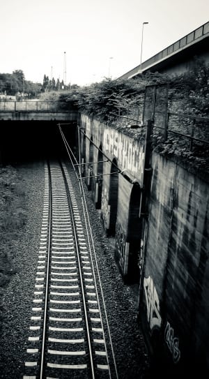 grey scale photo of tunnel railroad thumbnail