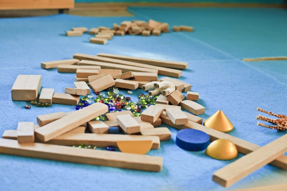 wooden blocks with beads on blue ceramic floor tile preview