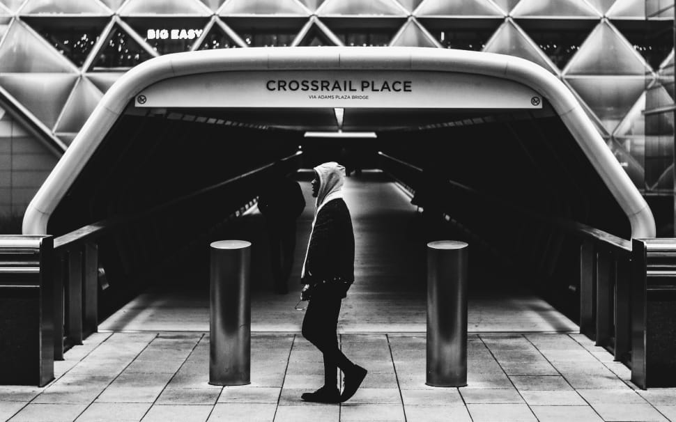 grayscale photo of man in center of crossfail place preview