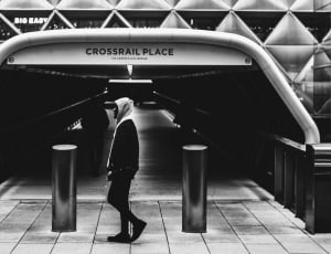 grayscale photo of man in center of crossfail place thumbnail
