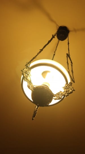 black metal frame pendant lamp creating shadow on ceiling thumbnail
