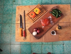 brown wooden cutting board and bell peppers thumbnail