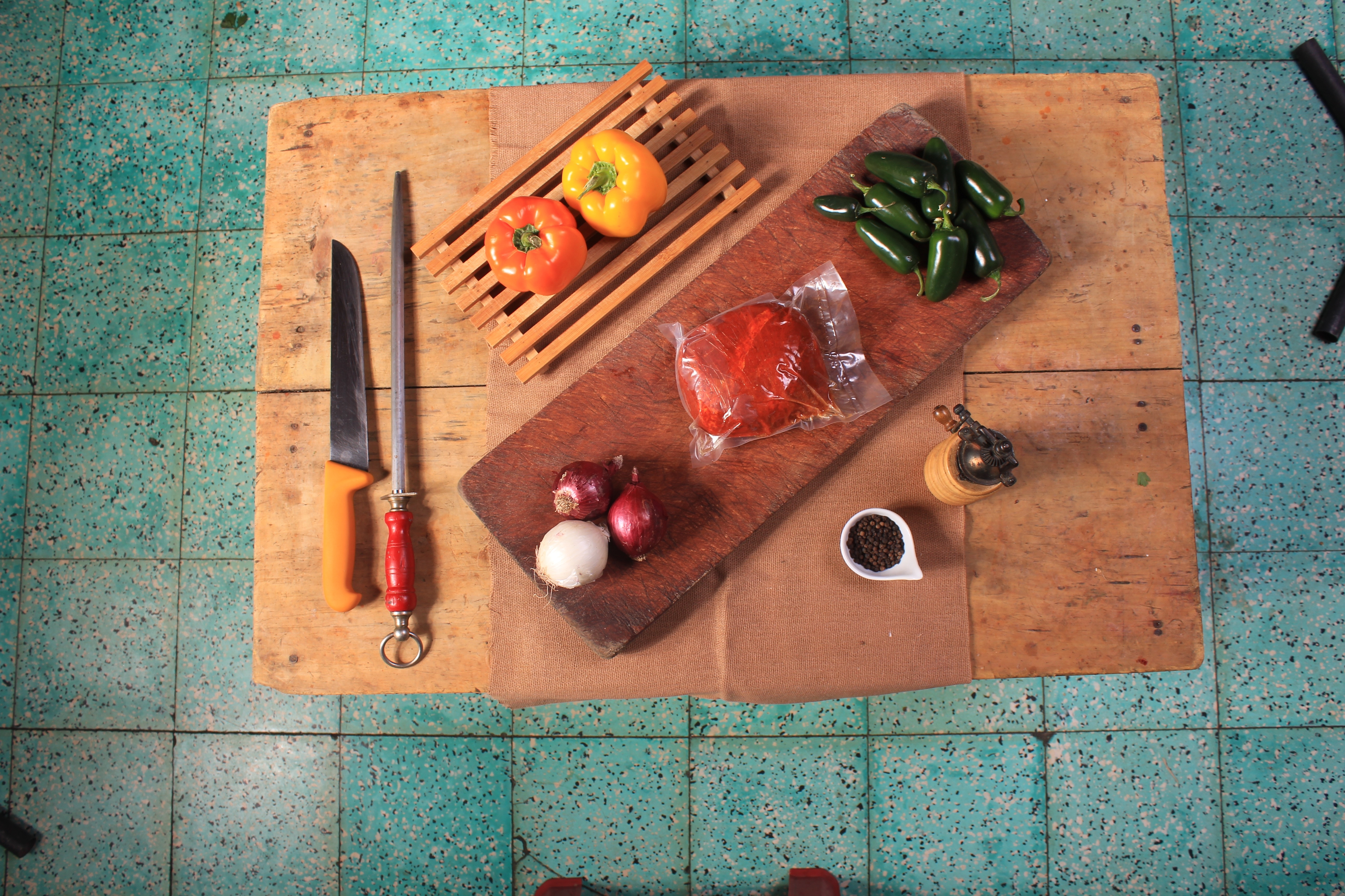 brown wooden cutting board and bell peppers