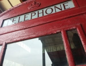 red wooden telephone booth thumbnail