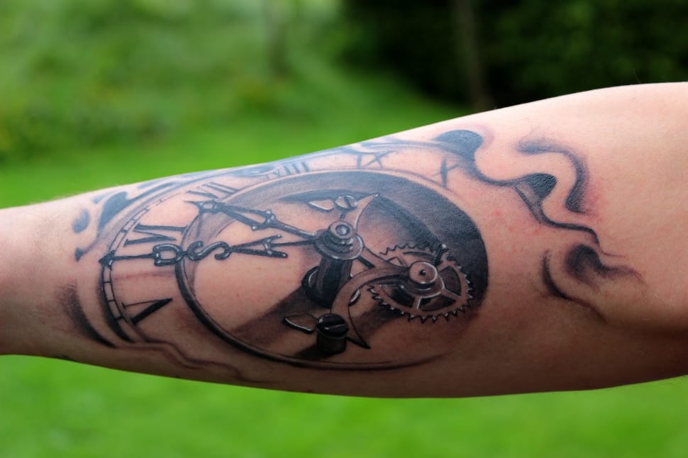 Liam Payne's black and grey clock and gear tattoo on