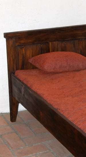 brown wooden bed frame with red fabric padded bed mattrsss thumbnail