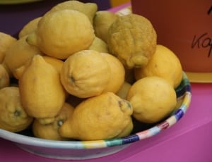 yellow lemons on round multi color bowl thumbnail