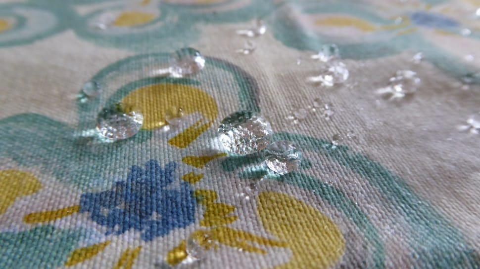 water drop on yellow and blue floral textile preview