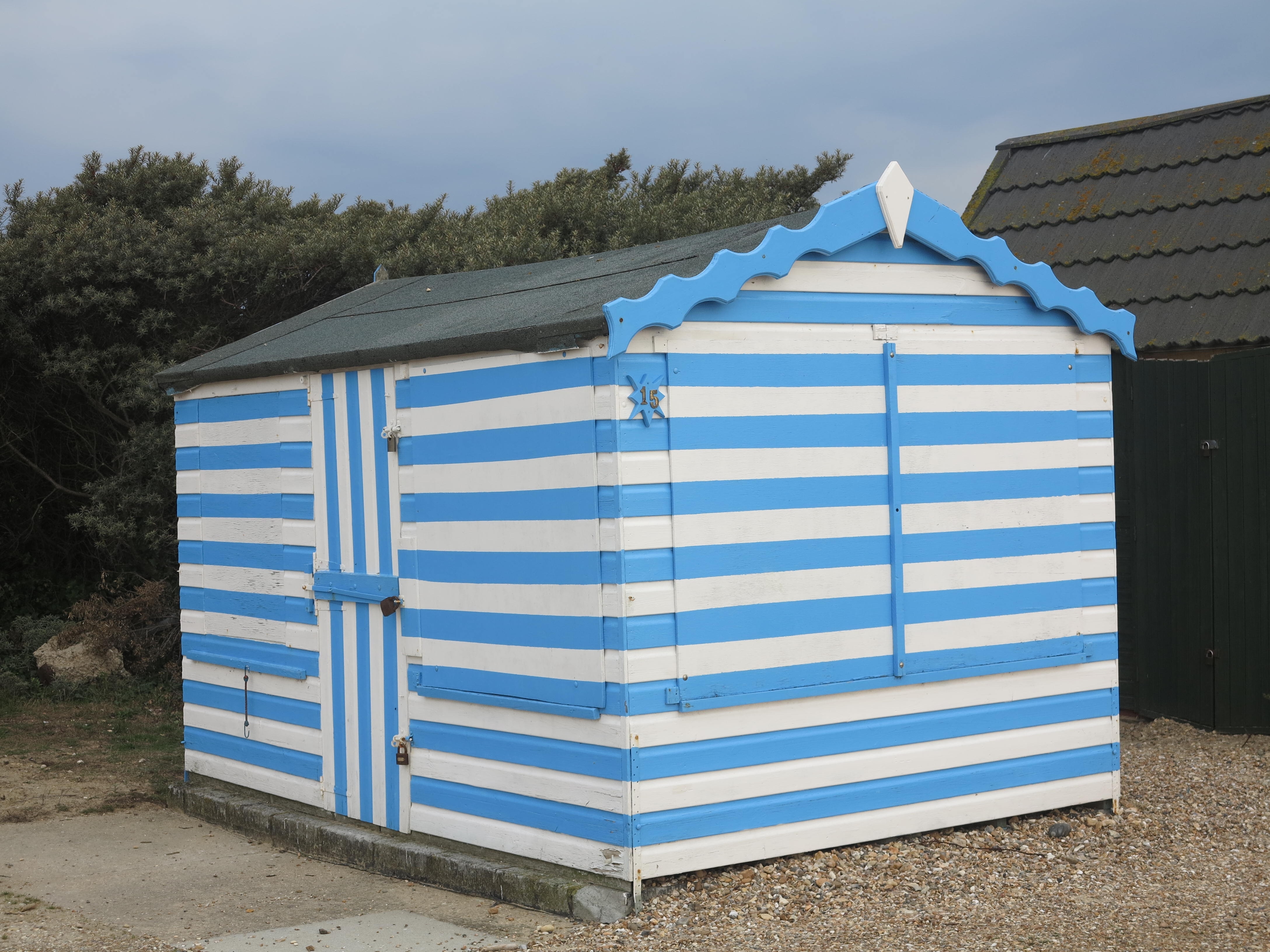 white and blue wooden shed